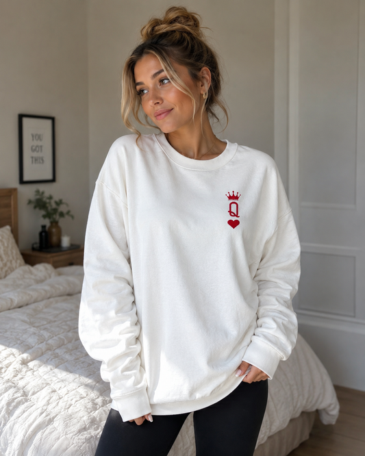 Queen sweatshirt worn by model, white with red crown Q and heart embroidery